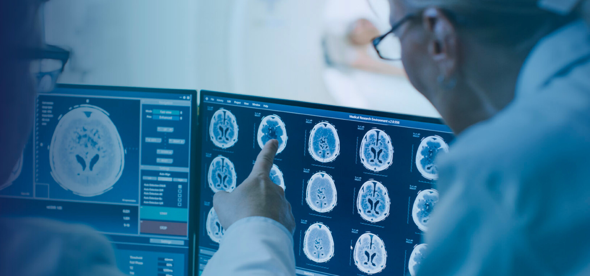 Doctors pointing to scan results on a monitor